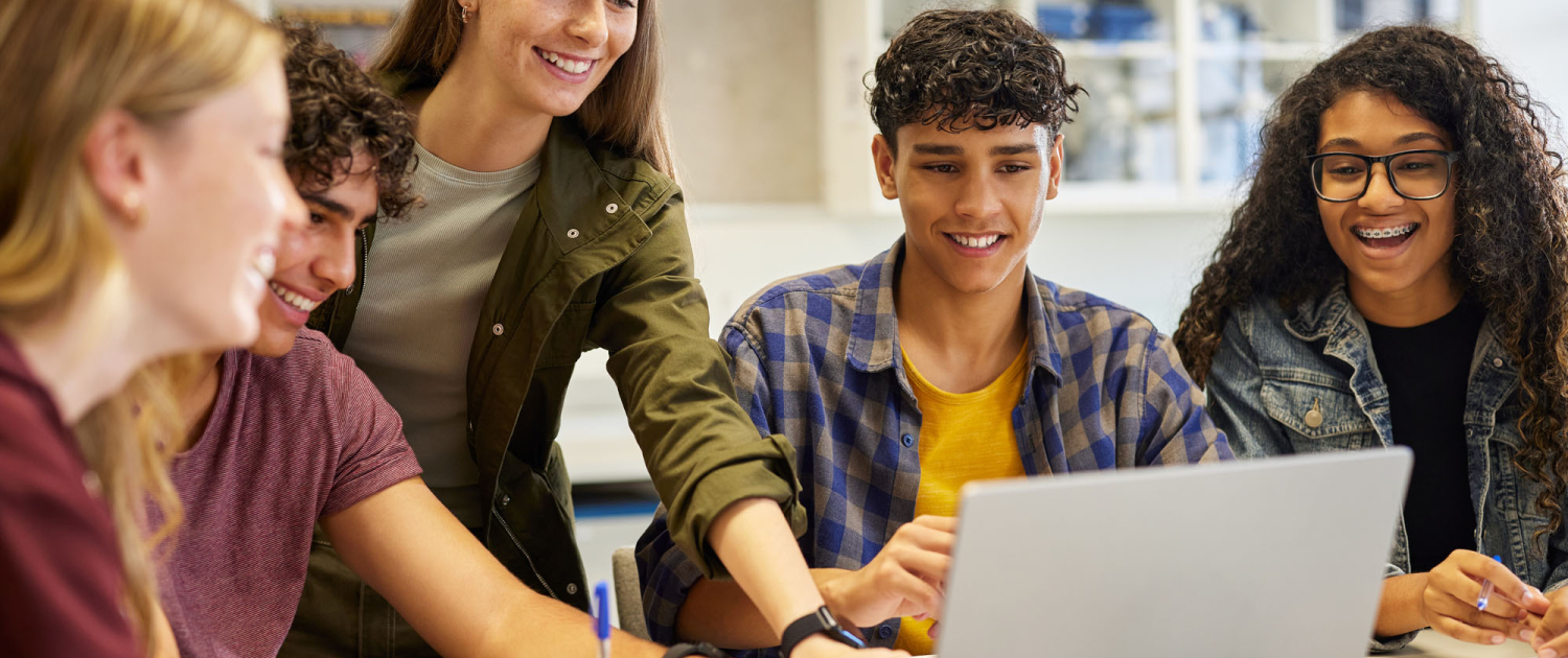 Happy smiling teens students studying in group