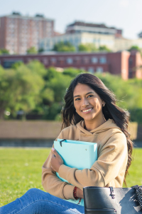 young girl with a blue folder, walking and studying on the campu